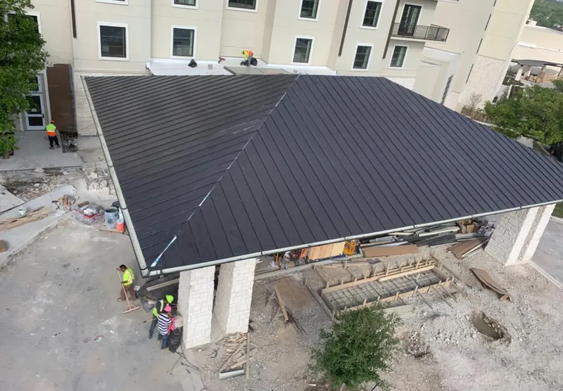 Metal roofing installation team working on a commercial building in Sparks